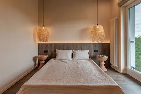 Sypialnia z łóżkiem, drewnianymi akcentami i lampami w stylu boho