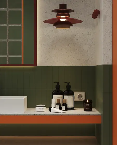 Wnętrze łazienki w stylu art deco z zielonymi i pomarańczowymi detalami.