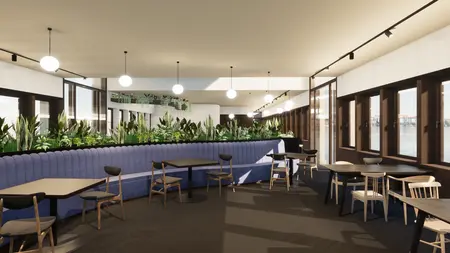 Wnętrze kawiarni z roślinami, niebieskimi kanapami i drewnianymi stołami. Styl: art deco, vintage, industrialny.