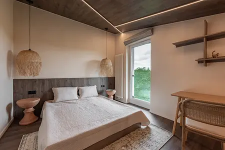 Sypialnia w stylu boho i skandynawskim z drewnianymi elementami.