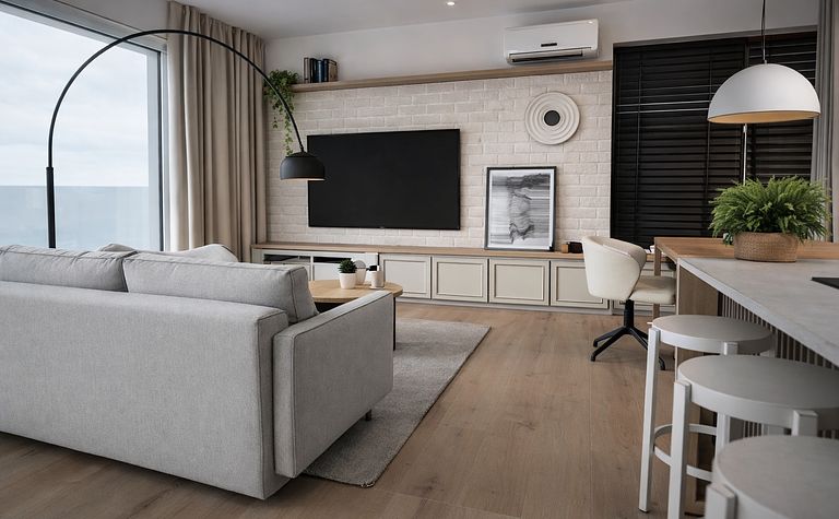 Wnętrze salonu w stylu japandi i minimalistycznym z szarymi meblami.