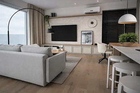 Wnętrze salonu w stylu japandi i minimalistycznym z szarymi meblami.