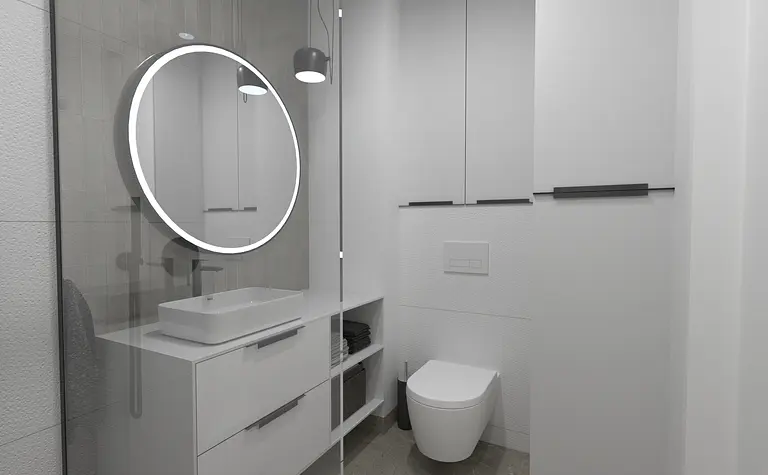 Nowoczesna łazienka z minimalistycznym designem, okrągłym lustrem, białymi meblami.