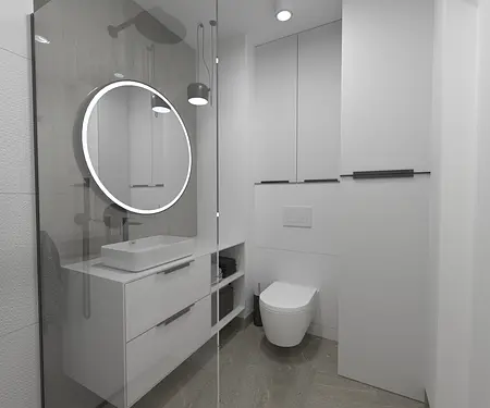 Nowoczesna łazienka z minimalistycznym designem, okrągłym lustrem, białymi meblami.