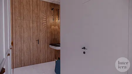 Eklektyczne wnętrze z drewnianą ścianą i białym blatem.