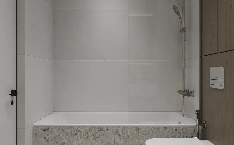 Nowoczesna łazienka z szarymi płytkami, wanną i drewnianymi detalami, minimalistyczny styl.