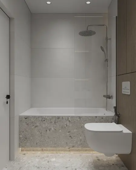 Nowoczesna łazienka z szarymi płytkami, wanną i drewnianymi detalami, minimalistyczny styl.