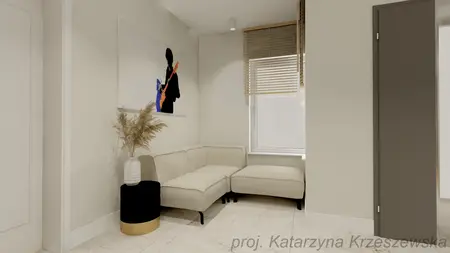 Wnętrze kącika wypoczynkowego z jasną sofą i obrazem, nowoczesny design.