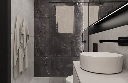 Wnętrze minimalistycznej łazienki z białą umywalką i czarnymi akcentami.