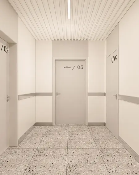 Korytarz w minimalistycznym stylu z szarymi ścianami i nowoczesnymi drzwiami.