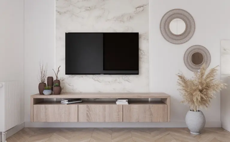 Wnętrze salonu w stylu tradycyjnym z telewizorem, drewnianą komodą oraz dekoracjami.