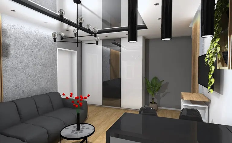 Wnętrze salonu w stylu industrialnym z czarną sofą, szarymi ścianami i rośliną.