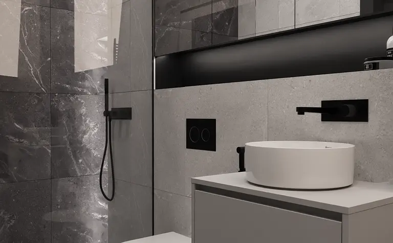 Minimalistyczna łazienka z szarymi płytkami i białą umywalką, nowoczesne oświetlenie.