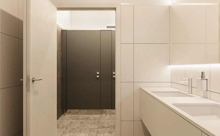 Wnętrze nowoczesnej łazienki z minimalistycznym designem i szarymi płytkami.