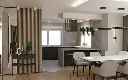 Nowoczesna kuchnia z szarymi meblami, drewnianym blatem i roślinami.