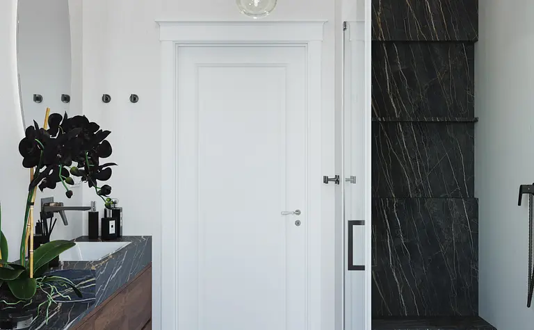 Nowoczesna łazienka z minimalistycznym designem, czarną zabudową i drewnianymi elementami.