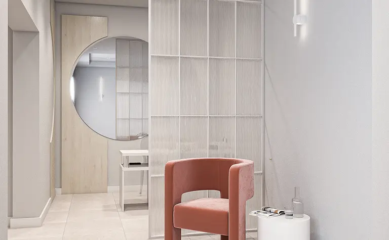 Przedpokój w minimalistycznym stylu z beżowym fotelem i białymi ścianami.