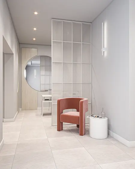 Przedpokój w minimalistycznym stylu z beżowym fotelem i białymi ścianami.