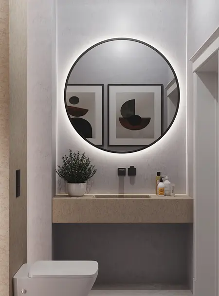 Minimalistyczna toaleta z okrągłym lustrem i nowoczesnym blatem. Wnętrze w stylu quiet luxury.
