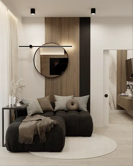 Stylowy salon z czarną sofą, drewnianą ścianą i nowoczesnym oświetleniem.