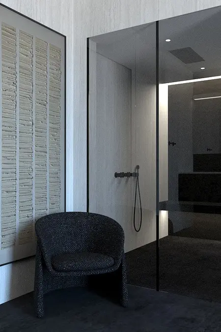 Wnętrze łazienki w minimalistycznym stylu z szarymi ścianami i czarnym fotelem.