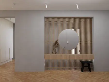 Wnętrze holu w stylu japandi i soft minimalizm z drewnianą konsolą i okrągłym lustrem.