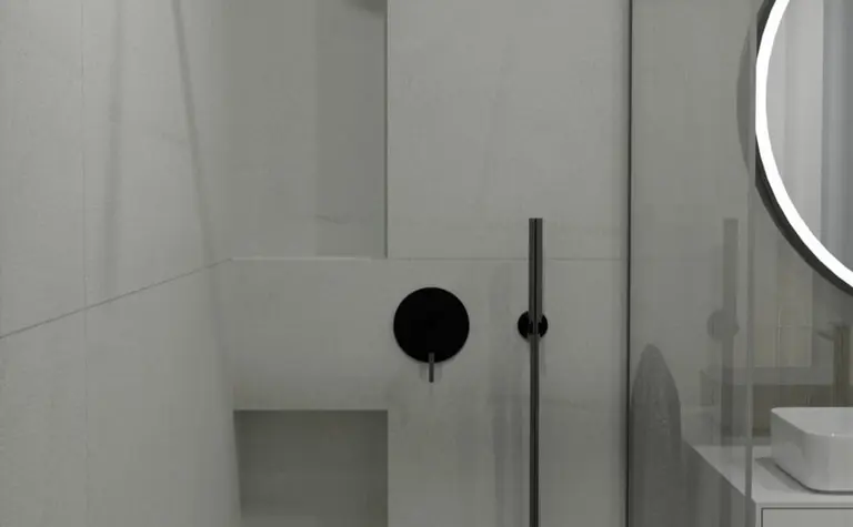 Nowoczesna łazienka z minimalistycznym prysznicem i białymi meblami.