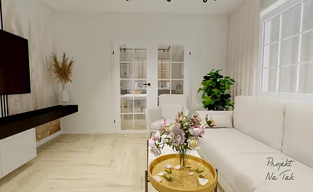 Wnętrze salonu z białą sofą, drewnianym stolikiem i roślinami.