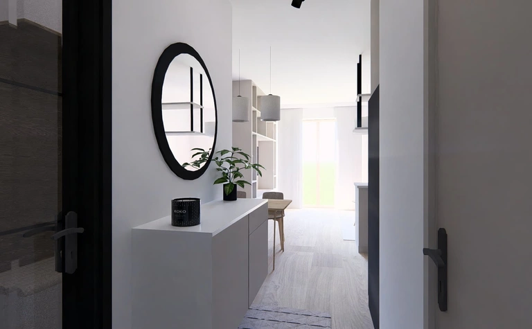 Przedpokój w stylu minimalistycznym z białymi meblami i czarnymi detalami.